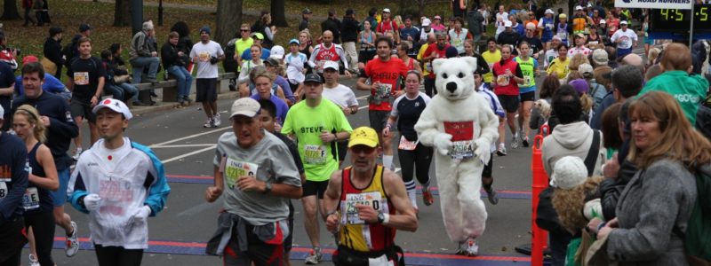 A person in a polar bear costume running a marathon